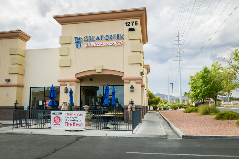 Street view of The Great Greek Mediterranean Grill, a restaurant with outdoor seating, located at 1275. A banner outside thanks Las Vegas for being the best. The sky is overcast, and there are power lines visible. Street view of The Great Greek Mediterranean Grill, a restaurant with outdoor seating, located at 1275. A banner outside thanks Las Vegas for being the best. The sky is overcast, and there are power lines visible.
